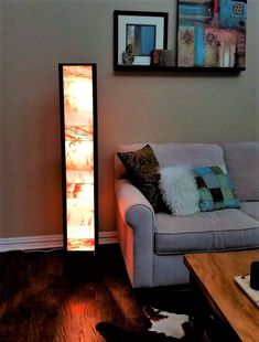 a living room with a couch, table and pictures on the wall