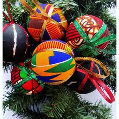 a bunch of ornaments hanging from a christmas tree with ribbons on it's ends