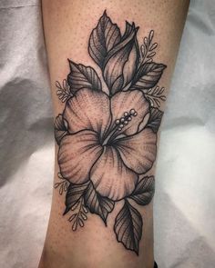 a black and white flower tattoo on the leg