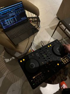 a laptop computer sitting on top of a dj's desk