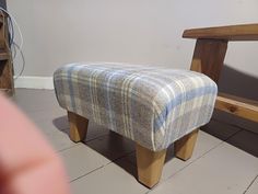 a foot stool sitting in front of a wooden bench