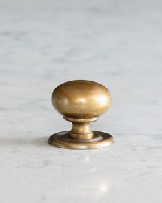 an antique brass door knob on a marble surface