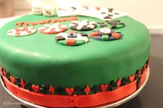 a green cake decorated with dice and hearts