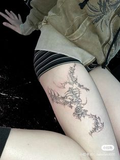 a woman's legs with tattoos on them