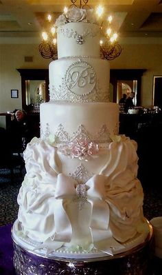 a large white wedding cake sitting on top of a table