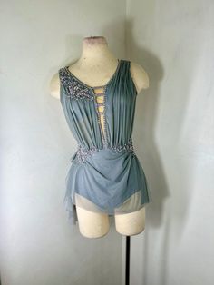 a mannequin wearing a blue dress with beading