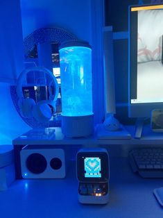 a desktop computer sitting on top of a desk next to a keyboard and monitor with a blue light