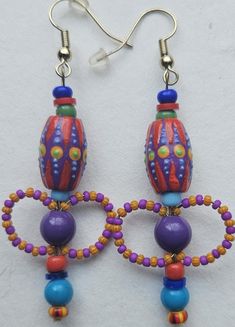 I start these earrings by painting wooden beads. I add glass and plastic beads in similar and contrasting colors. They are very lightweight. Shipping is included. Bohemian Multicolor Wooden Bead Earrings, Multicolor Wooden Beads Dangle Earrings, Unique Multicolor Large Beads Earrings, Unique Multicolor Earrings With Large Beads, Multicolor Wooden Beads Round Earrings, Multicolor Wooden Beaded Earrings, Multicolor Wooden Beaded Round Earrings, Multicolor Dangle Beaded Earrings With Wooden Beads, Artistic Multicolor Round Bead Earrings