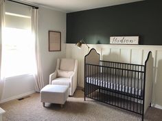 a baby's room with a crib, chair and window