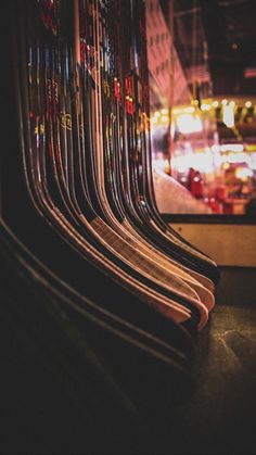 rows of skis are lined up in front of a window with the city lights behind them