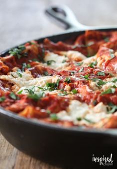 a close up of a pizza in a pan on a table