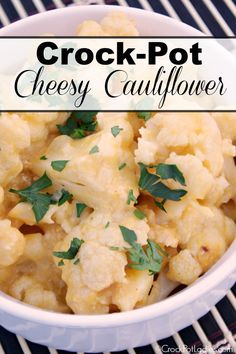 crock pot cheesy cauliflower in a white bowl with parsley on top