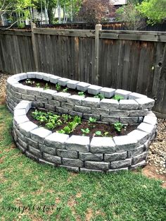 a garden bed made out of rocks in the yard