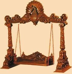 an ornate wooden bed frame with chains hanging from it