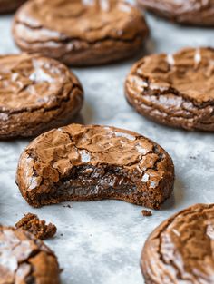 chocolate cookies with frosting are on a baking sheet