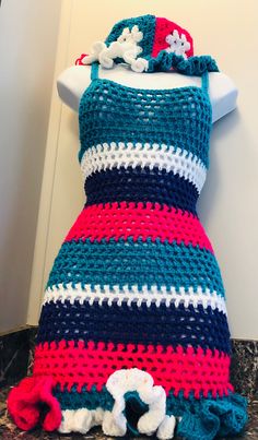 a crocheted dress sitting on top of a mannequin's head