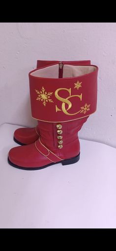 a pair of red boots sitting on top of a white table