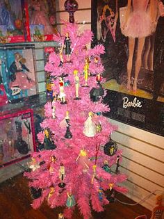 a pink christmas tree with barbie dolls on it