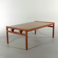 a wooden table sitting on top of a white floor