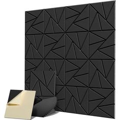 an image of a black and white wall with some paper on it, next to a piece of tape