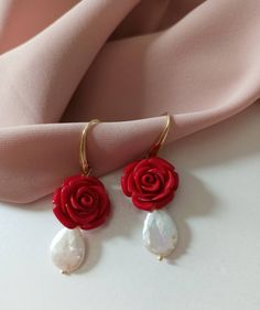 Drop earrings made of: - Baroque Pearl drops (18 mm x 12 mm), white color; - Resin Roses, red color; - Gold plated 925 Silver hooks. Lenght : 5 cm / 1,97 inches * SHIPPING * Your order will be shipped within 1-3 business days from your purchase. You can choose between 2 shipping methods: STANDARD MAIL (NOT TRACEABLE) It is a cheap and fast shipping method, but NOT TRACEABLE. Chapeau Atelier is not responsible for any postal disruptions, delays or losses. REGISTERED MAIL (TRACEABLE) It is an abso Red Dangle Jewelry With Rose Design, Red Rose Design Dangle Jewelry, Elegant Rose Red Dangle Jewelry, Red Pearl Drop Earrings As Gift, Red Pearl Drop Earrings For Gift, Red Rose Design Drop Earrings, Red Rose Jewelry For Wedding, Elegant Red Rose Design Earrings, Elegant Rose Red Earrings Gift