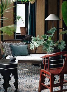 a living room filled with furniture and plants