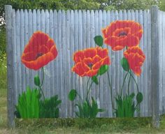 an image of painted flowers on a fence