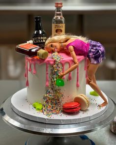 a birthday cake decorated with a barbie doll and confetti sprinkles