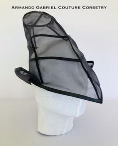 The Wicked Witch is one of the most iconic characters from the Wizard of Oz universe. This headdress in black mesh, complete with visor, will add a classy touch to any costume or outfit, creating an inspired yet fashion forward look. The item will fit a standard head circumference of 56cm - 58 cm. Witchy Black Costume Hats For Cosplay, Fitted Halloween Evening Hats, Fitted Hats For Halloween Evening, Adjustable Black Fantasy Costume Hats And Headpieces, Black Fitted Fantasy Costume Hats And Headpieces, Black Fantasy Costume Hats And Headpieces For Halloween, Witchy Black Costume Accessories For Festival, Black Mini Hat For Halloween Cosplay, High Crown Costume Hats For Halloween Cosplay