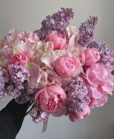 a bouquet of pink and purple flowers in a vase