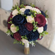 a bridal bouquet with red, white and blue flowers