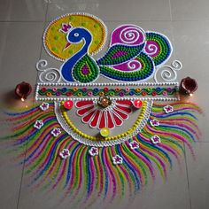 colorful peacock design on the floor with candles and decorations for diwaling or decorating