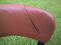 a close up of a brown leather seat on a motorcycle