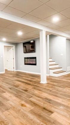 an empty room with hard wood floors and white walls