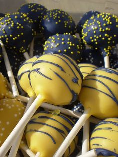 yellow and blue cake pops are in a box