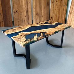 a wooden table sitting on top of a white floor next to wood paneled walls