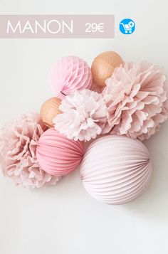 pink and gold tissue pom poms are arranged on a white background with the words manon 209