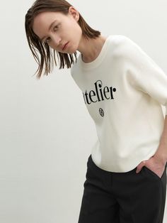 Casual and trendy knit sweater featuring the 'atelier' and logo embroideries at front. The basic rounded neckline, relaxed silhouette, and classic colorway are easy to style with various bottoms. - Rounded neckline and half-sleeved design- Ribbed trim at neckline, sleeve hems, and hem- Relaxed and comfortable silhouette- 'atelier' and logo embroideries at front Classic Sweater With Embroidered Logo In Relaxed Fit, Classic Relaxed Fit Sweater With Embroidered Logo, Classic Relaxed Fit Logo Print Sweater, Classic Sweater With Embroidered Logo And Relaxed Fit, Classic Winter Top With Embroidered Logo, Winter Tops With Embroidered Logo For Everyday, Classic Tops With Logo Print For Workwear, Trendy Knit Sweaters, Rounded Neckline