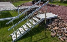 an aerial view of some stairs in the middle of a grassy area with rocks and grass