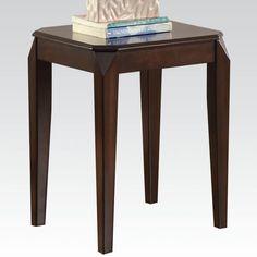 a small wooden table with books on top