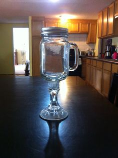 a glass mug sitting on top of a counter