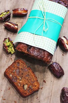 a piece of bread sitting on top of a wooden cutting board next to figs