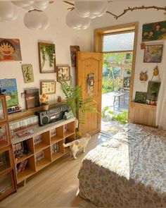 a bedroom with a bed, bookshelf and pictures on the wall