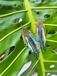 Beautiful and colorful beaded fringe earrings with matte gold, shades of blue, yellow and cream Toho seed beads. This dangly natural colors pair will complete your outfit with a bohemian touch. wear for any occasion and makes a perfect gift. Approximate measuring: Length- 4.1" Width-  1" Ear wire is made of iron, nickel free. each pair is handmade with love, made to order. Yellow Fringe Dangle Jewelry, Summer Gold Beaded Fringe Jewelry, Summer Gold Jewelry With Beaded Fringe, Gold Jewelry With Beaded Fringe For Summer, Yellow Beaded Fringe Earrings For Festival, Gold Beach Jewelry With Beaded Fringe, Fringe Beaded Earrings, Gold Shades, Measuring Length