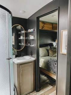 a bathroom with a sink, mirror and shower stall in the corner next to it