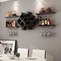 a dining room table with wine glasses and bottles on the wall