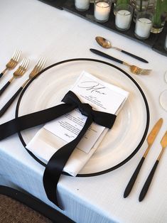 the table is set with black and white place settings