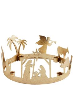 a gold metal nativity scene with palm trees and an angel in the middle, on a white background