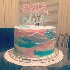 a cake that is sitting on top of a glass table with the words happy birthday written in frosting