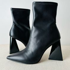 Brand New, No Box, Price Is Firm. Make A Statement In Any Outfit With The Ticker Bootie From Steve Madden. This Ankle Boot Features A Unique Triangular Block Heel That Complements The Pointed Toe For Added Drama. Inside Zipper Closure Pointed Toe Textile & Synthetic Lining Padded Footbed Approx. 6" Shaft Height Approx. 10" Leg Opening 4" Triangle Block Heel Tags: A-Line Animal Abstract Bright Babydoll Boho Bootcut Bustier Beaded Braided Boyfriend Boxy Bell Sleeve Backless Baggy Belted Bustier Bo High Heel Black Faux Leather Boots, Black High Heel Faux Leather Boots, Black Faux Leather High Heel Boots, Square Toe Medium Width Heeled Boots For Party, Square Toe Heeled Boots For Party, Black Faux Leather High Ankle Heeled Boots, Party Heeled Boots With Square Toe, Modern Square Toe Boots For Night Out, Black Pointed Toe Heels For Fall